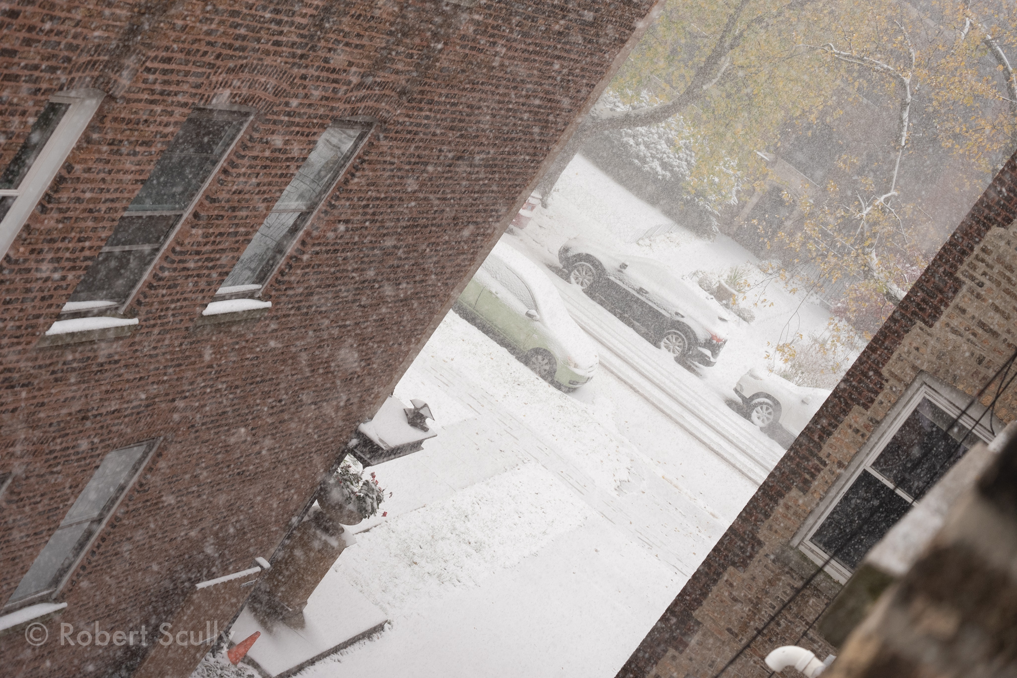 A view down the alley to the street from three floors up, tilted at a Dutch angle for drama’s sake.